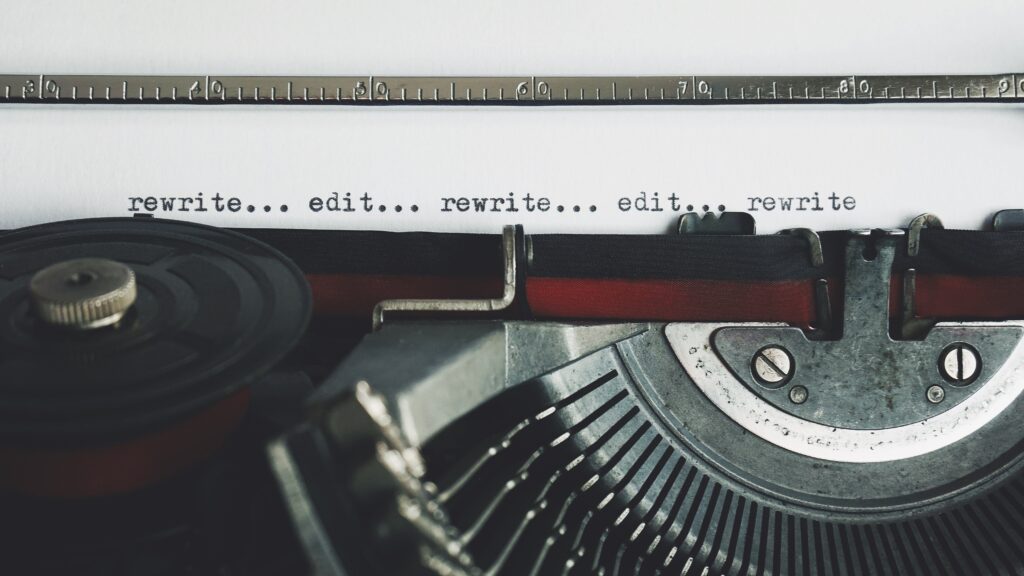 typewriter of copy editor showing words printed saying "rewrite...edit..." repeated in a single line