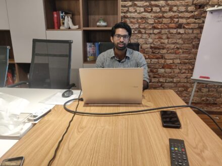 Young man talking into laptop